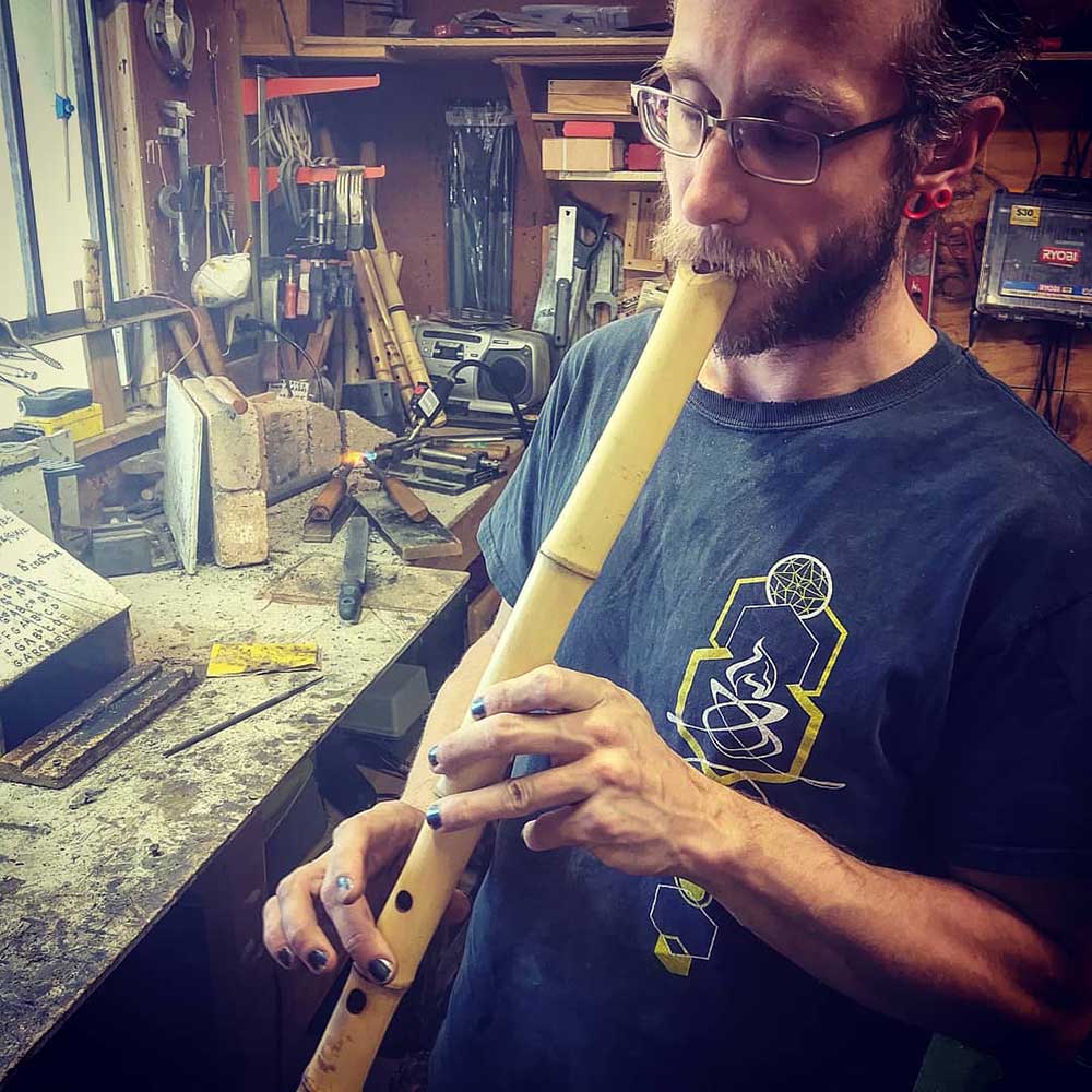 Josh tuning a shakuhachi in the workshop